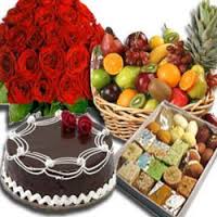 Half Kg Mix Barfi with 1/2 Kg Chocolate Cake and 12 Red roses bouquet 2 kg Fresh fruits basket