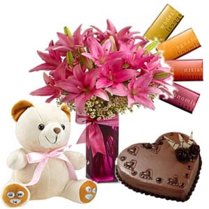 6 lilies vase, 4 temptation chocolates, 1/2 kg Cake,Â  6 inch teddy