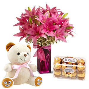 Flowers in a vase with chocolates+ teddy