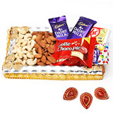 Cashews and almonds in a decorated tray with chocolates