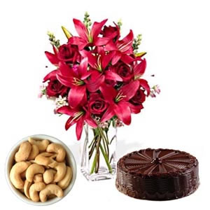 6 lilies in a vase with 200 gm cashews and 1 kg chocolate cake