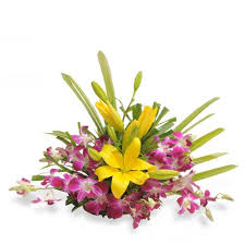 Yellow lilies and orchids in a basket