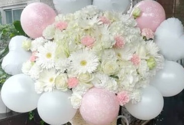 50 White roses stuffed in between 15 white balloon bouquet