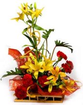 lilies and carnations in a wicker basket