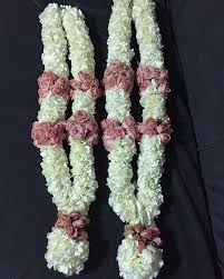 Wedding ceremony marriage traditional jaimala with fresh flowers pink white flowers for bride and groom