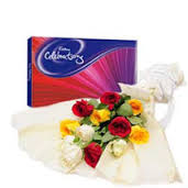 Bouquet of mixed flowers with box of Cadbury celebration