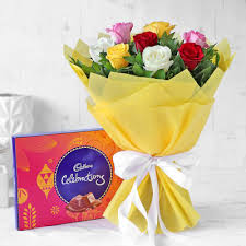 Bouquet of mixed flowers with box of Cadbury celebration