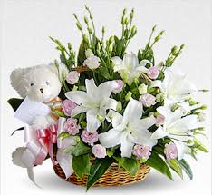 Lilies and teddy bear in a basket