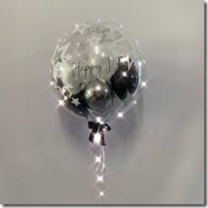 1 bubble transparent balloon with happy birthday print on balloon and black silver balloons inside