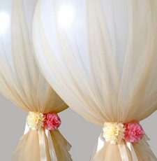 Two clear balloons covered with net and flowers