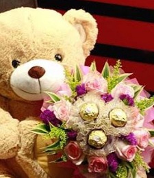 White or cream Teddy with bouquet of ferrero rocher chocolates and 6 pink roses