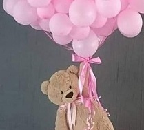brown teddy holding 20 pink helium balloons