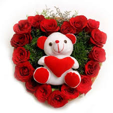 Heart of 24 red roses with teddy in the centre