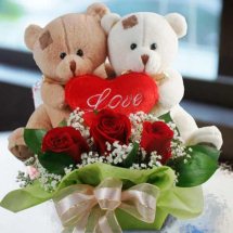2 Teddy bears (6 inches each) with short stems of 3 red roses and 3 inch valentine heart in the same Basket